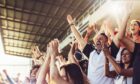 sports fans celebrating in stadium