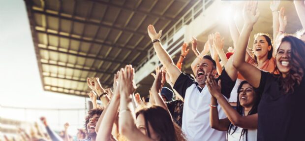 sports fans celebrating in stadium