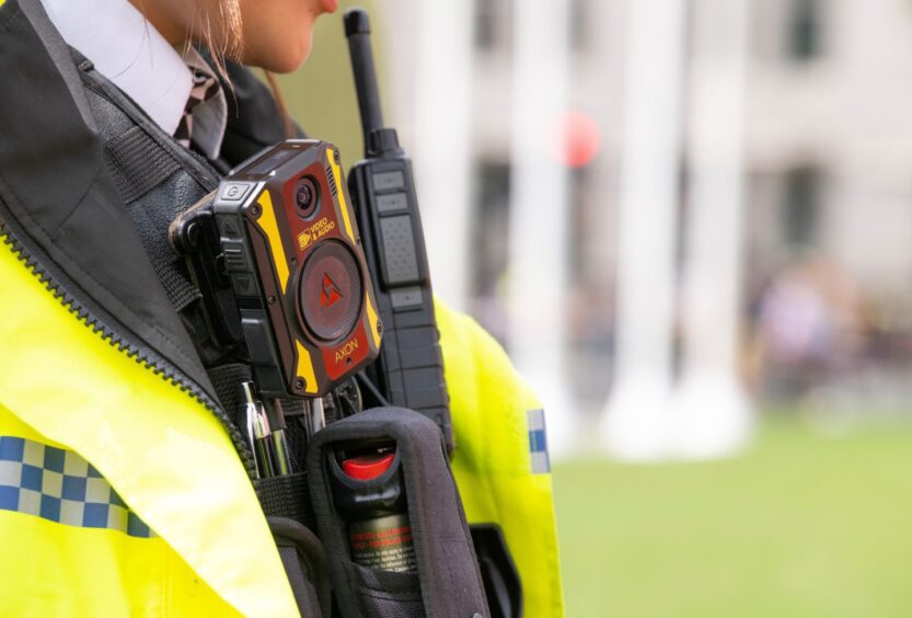 Police officer with body worn video camera on uniform