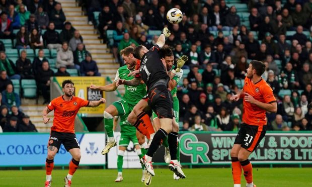 Dundee United's Jack Walton punches a high ball clear against Hibernian