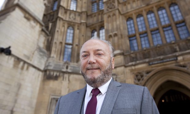 George Galloway outside the Houses of Parliament. Image: Shutterstock.