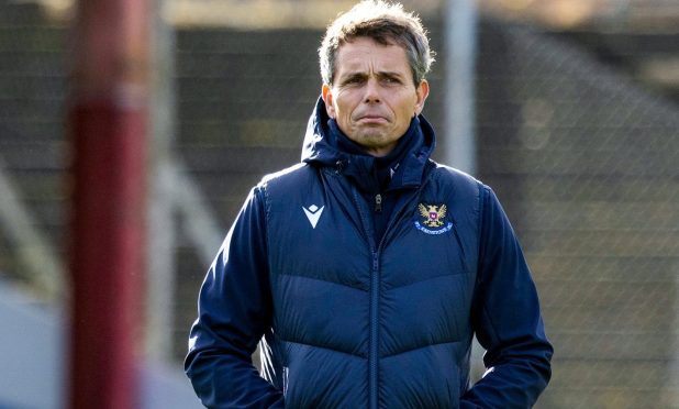 St Johnstone head coach, Simo Valakari, watches his team's warm-up before a Premiership game.