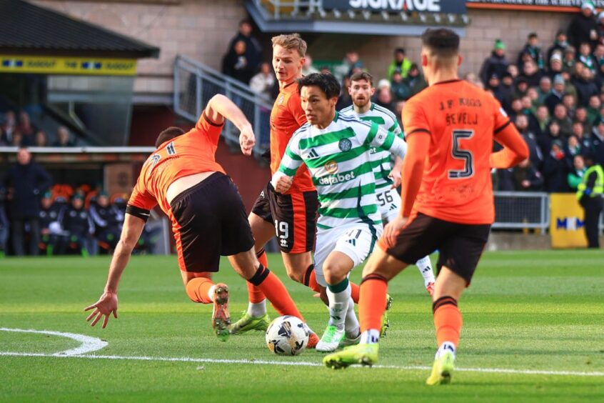 Celtic's Reo Hatate skips past Dundee United's Declan Gallagher towards the edge of the box