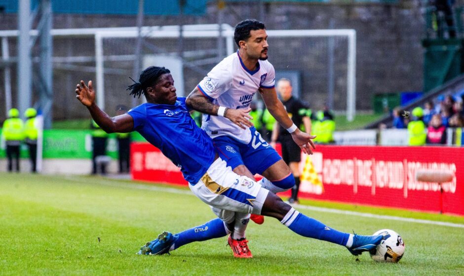 St Johnstone midfielder Aaron Essel makes a tackle in the game against Rangers.