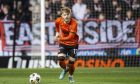 Luca Stephenson strides forward in possession for Dundee United