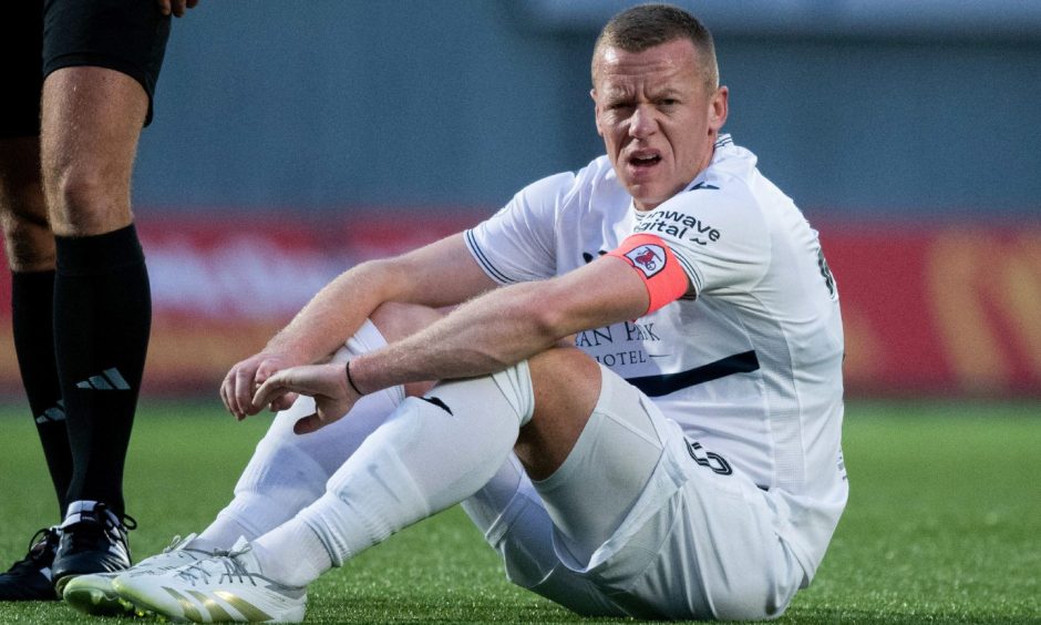 Raith captain Scott Brown sits on the ground at the Falkirk Stadium.