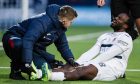 A sitting Fankaty Dabo is in agony as he receives treatment for an injury.