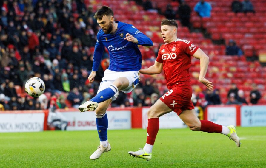 Former St Johnstone defender Kyle Cameron beats Aberdeen's Kevin Nisbet to the ball.