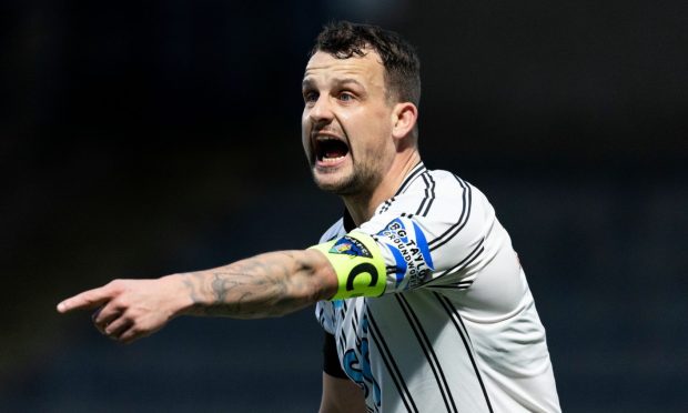 Dunfermline Athletic FC skipper Kyle Benedictus points and shouts.