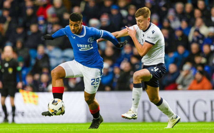 Dundee's Ryan Astley gets to grips with Rangers striker Hamza Igamane. Image: Craig Williamson/SNS