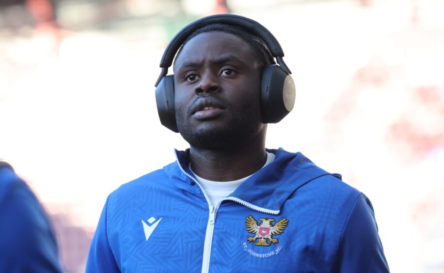 St Johnstone forward Benji Kimpioka listening on his headphones before a game.