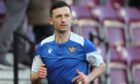 St Johnstone midfielder, Jason Holt, warms up before a game against Hearts.