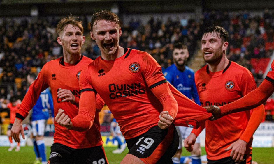 Dundee United's Sam Dalby wheels away in delight.
