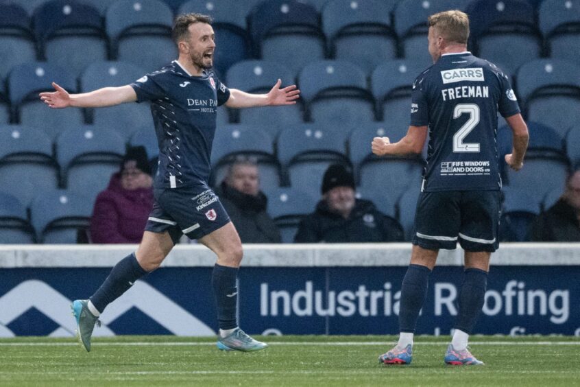 Aidan Connolly celebrates his goal with Kieran Freeman.