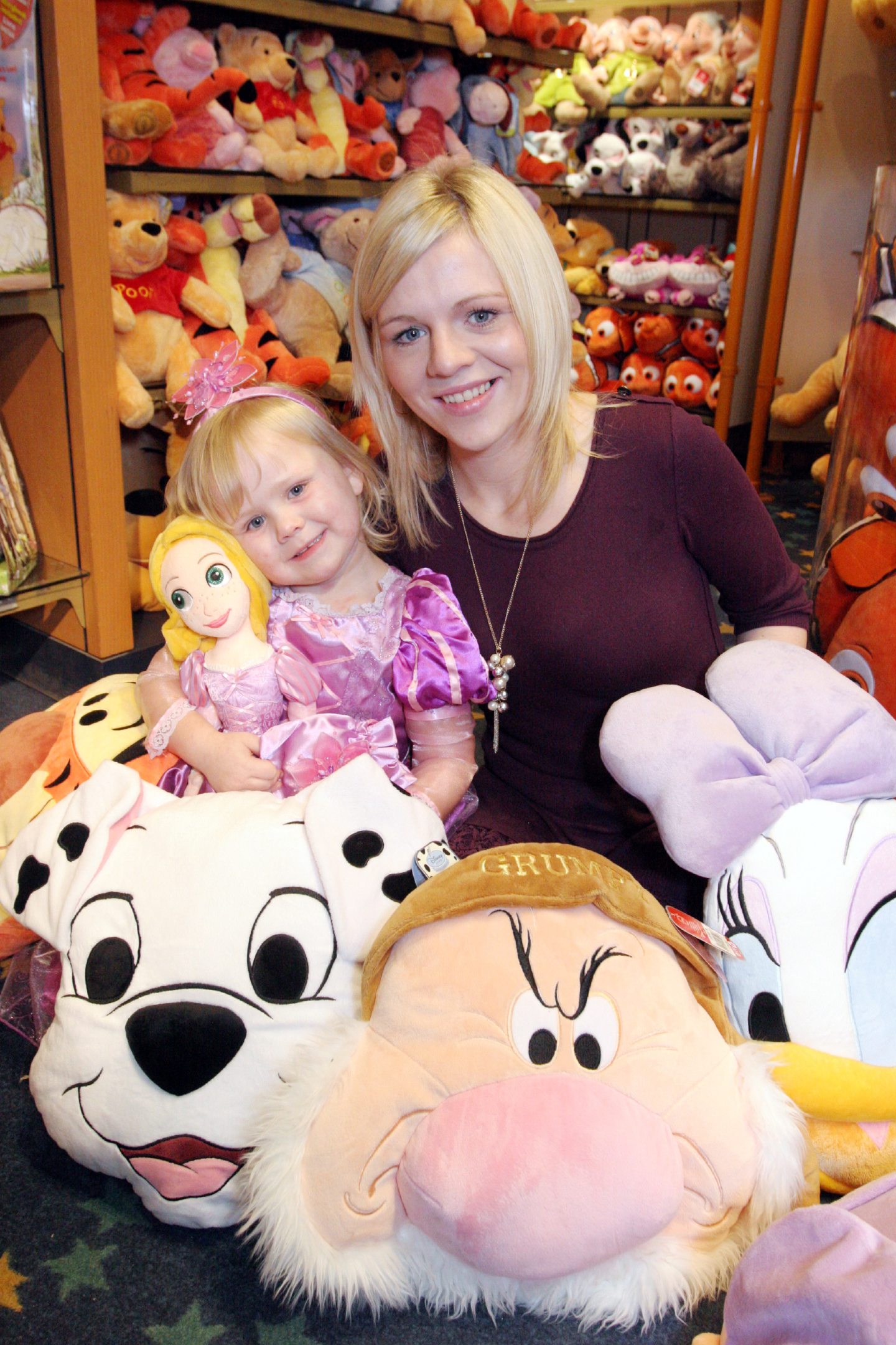 Becky Josie Whyte with mum Samantha Murray at the Disney Store, with some stuffed Disney soft toys 