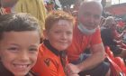 Mark Stuart at Tannadice with Reuben Stuart and Charlie Ellis (both aged 11). Image: Stuart Family.