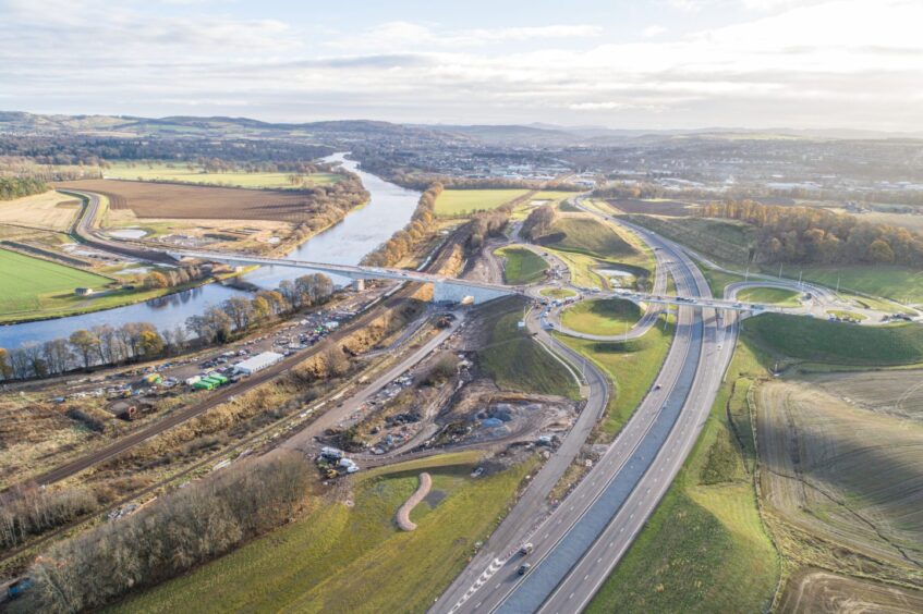 Aerial view of Cross Tay Link Road, from A9 with bridge over Tay and road stretching eastwards through countryside