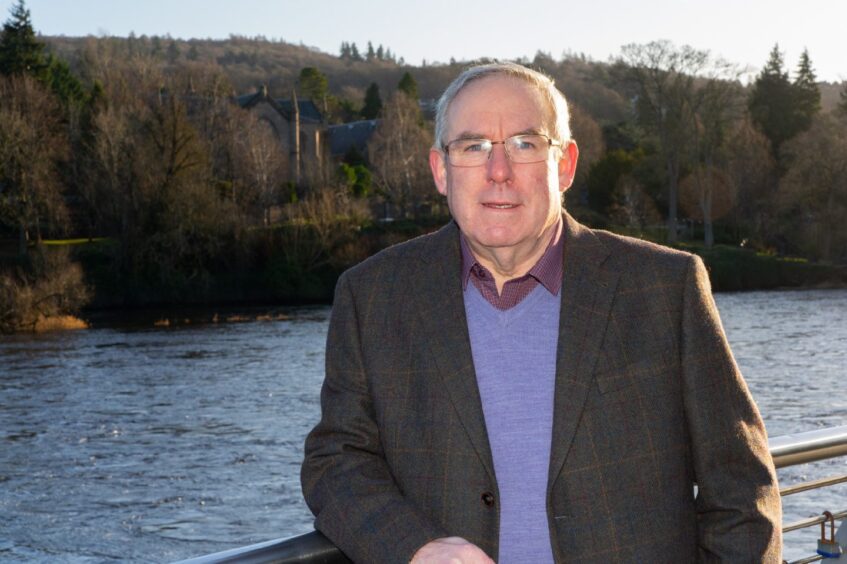 Chris Ahern standing next to River Tay