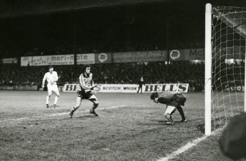 The Dons goalie with the ball, watched by Frank Kopel