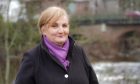 Blairgowrie councillor Caroline Shiers in front of river and bridge in centre of town