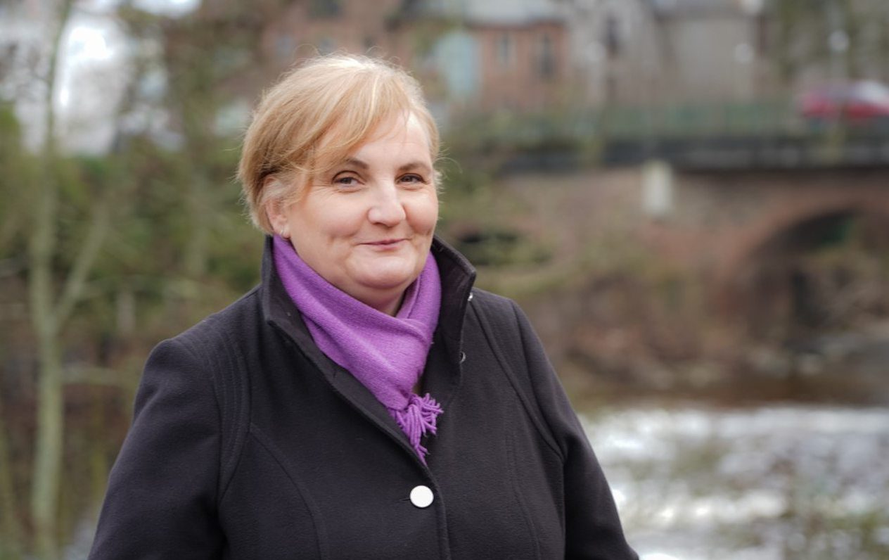 Blairgowrie councillor Caroline Shiers in front of river and bridge in centre of town