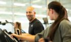 group of people run on treadmills as they focus on good health and fitness in Dundee