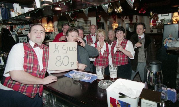 Simeon Stewart and customers toast the 80p quarter gill at the Dundee bar