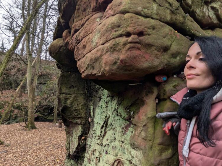 Gayle finds the carving of the bearded face at Dunino Den