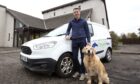 Gavin Thurston and golden retriever standing next to Thrums Vets van.