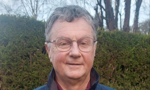 Campaigner Bill Wright standing in front of a hedge.