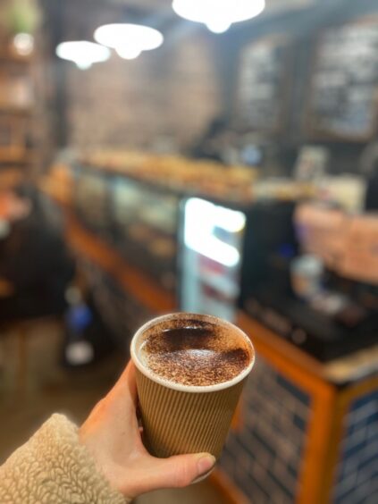 Espresso Lab's mint hot chocolate being held inside the café.