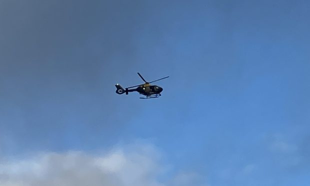 A police helicopter above Wormit on Monday. Image: Ellidh Aitken/DC Thomson