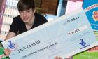 Jack Tanbini with Lottery win cheque