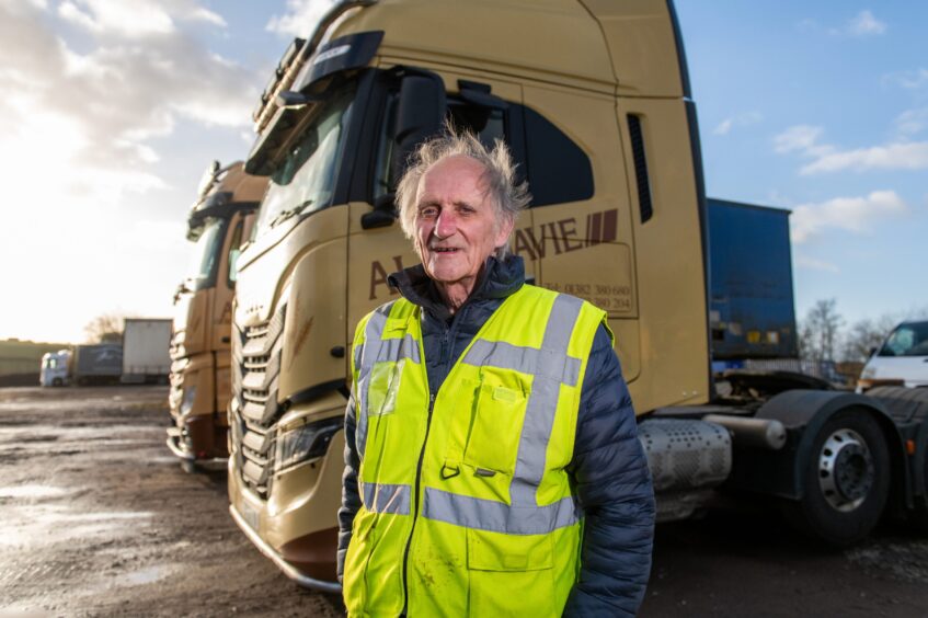  Alan Davie with a background of a couple of lorries in the yard,