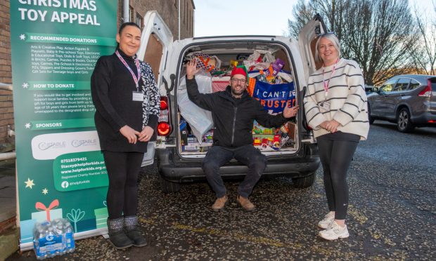 Charity manager Stacey Wallace (right) with Gary Rooney and Fiona Hain from Help for Kids. Image: Kim Cessford/DC Thomson