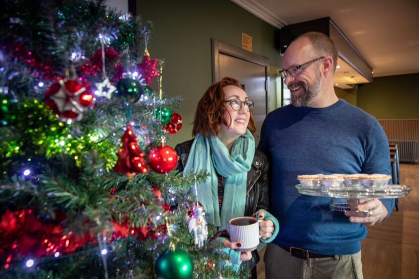 Hazel and Alasdair Lightbody next to Christmas tree at Alyth Hotel