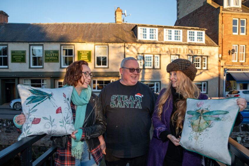 Hazel Lightbody, Steven Boath and Jilly Henderson smiling with Alyth Hotel behind them.