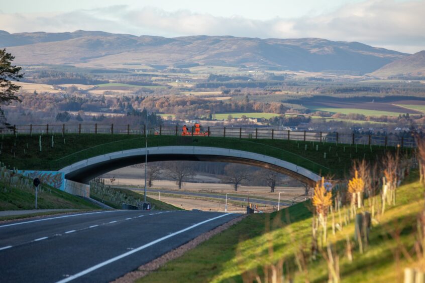 green bridge with Cross Tay Link Road underneath and Perthshire countryside beyond