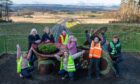Group of children next to 'living bench' sculpture on bridge over Cross Tay Link Road