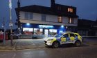 The shops in Invergowrie have been taped off. Image: James Simpson/DC Thomson