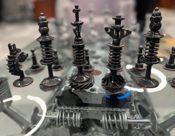 Chess pieces made from car parts