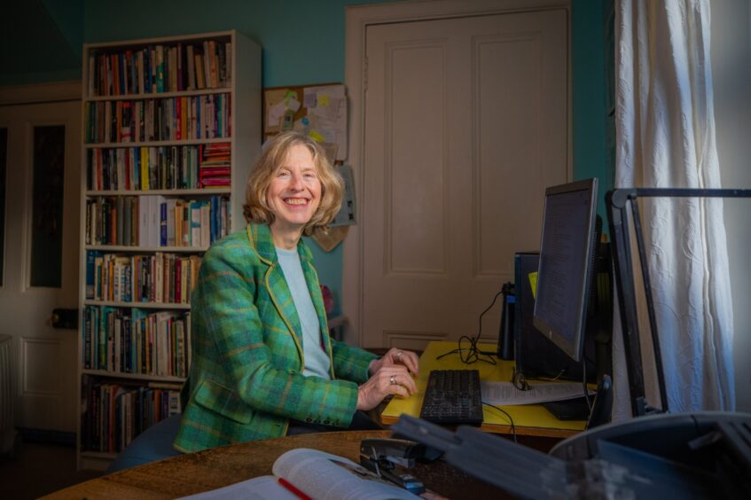 Writer Ajay Close sitting in her study in her Perth home.