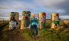 Fleur Baxter with her Wallace and Gromit characters beside the B9128 Forfar to Carnoustie road. Image: Steve MacDougall/DC Thomson