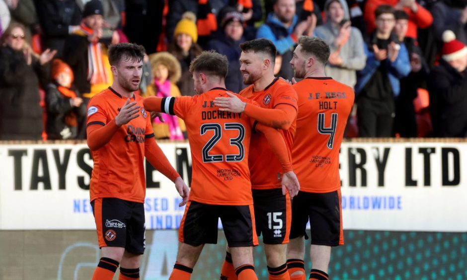 Dundee United players celebrate a hard won point against Celtic