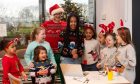 Children, and Rich, singing Christmas songs at
Santa's Breakfast in Tayport. Image: Alan Richardson