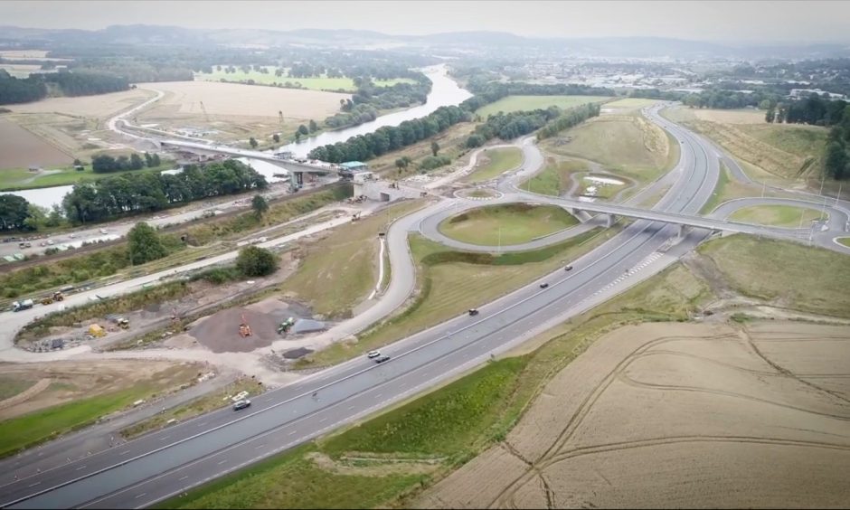 Drone image showing new Cross Tay Link Road interchange off A9 and Destiny Bridge across River Tay, north of Perth