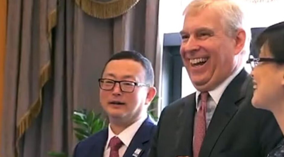 Yang Tengbo pictured beside a smiling Prince Andrew 