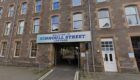 Kinnoull Street car park entrance, with sign saying 'welcome to Kinnoull Street car park' above entrance which leads through building to open area behind.