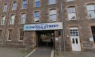 Kinnoull Street car park entrance, with sign saying 'welcome to Kinnoull Street car park' above entrance which leads through building to open area behind.