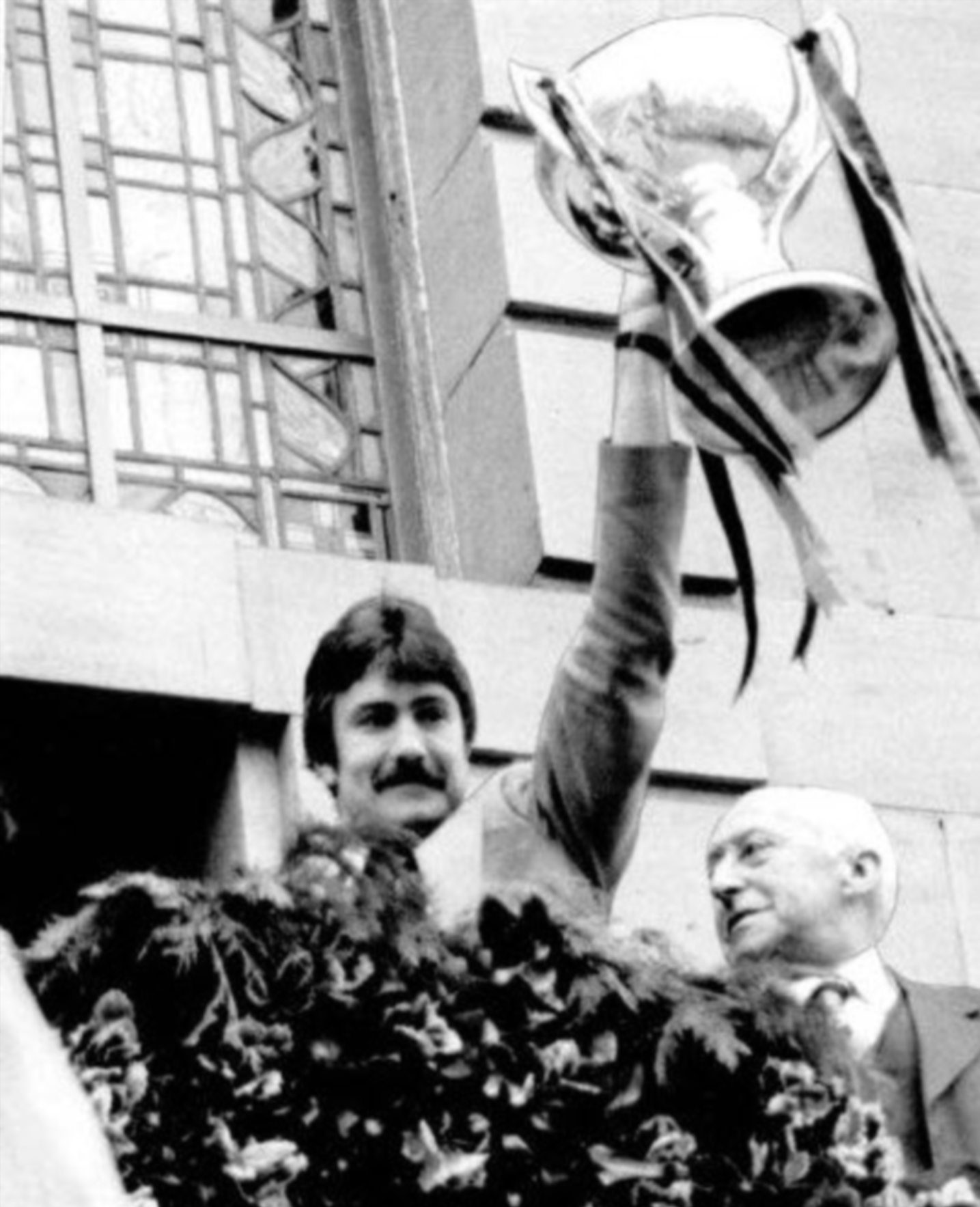 Hamish McAlpine on the City Chambers balcony showing off the cup.